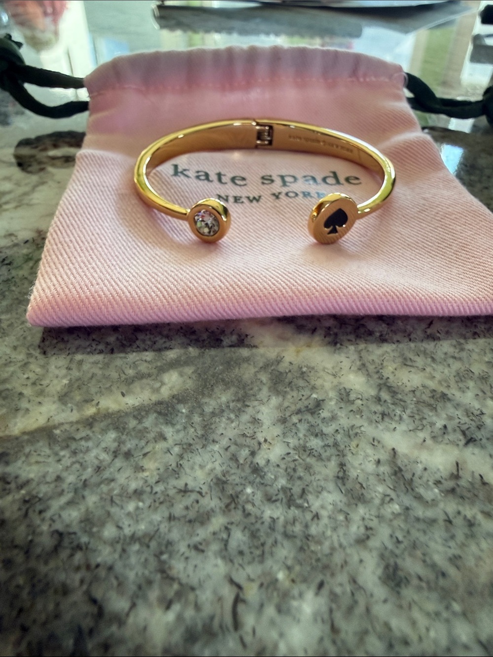 Kate Spade gold open cuff bracelet with clear crystal and black spade